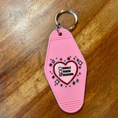 Single taken reading motel keychain