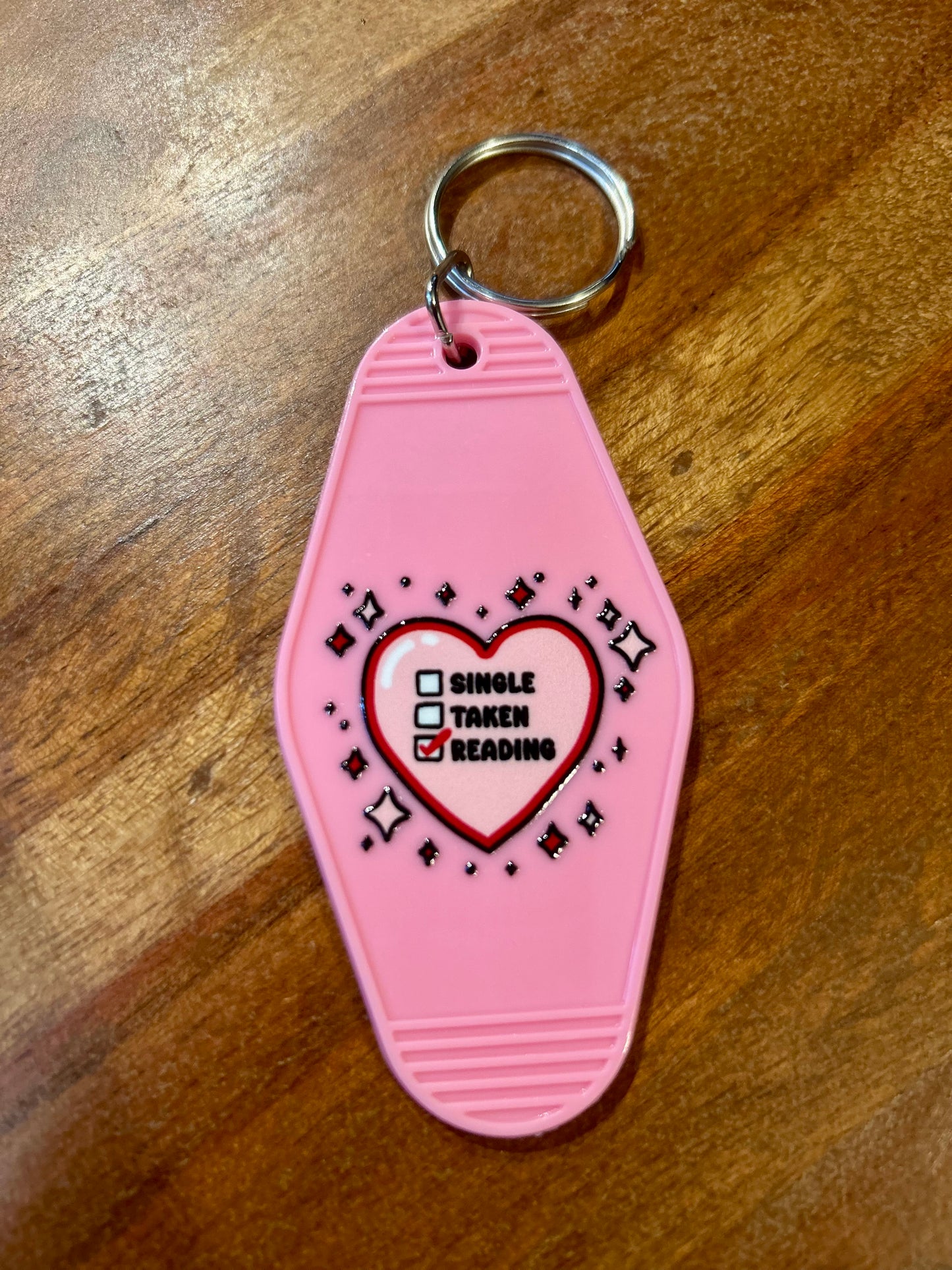Single taken reading motel keychain